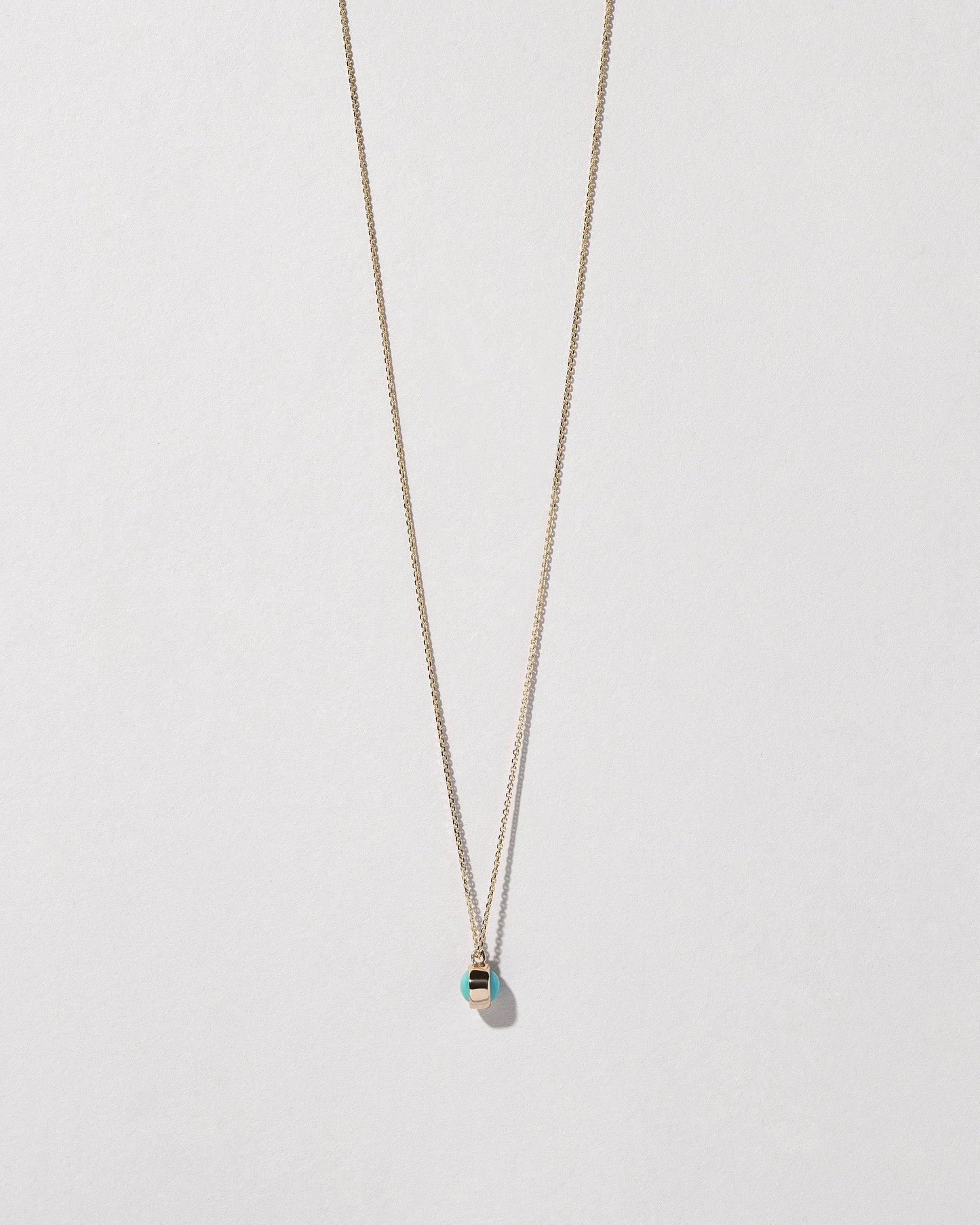 Turquoise Birthstone Necklace on light color background.