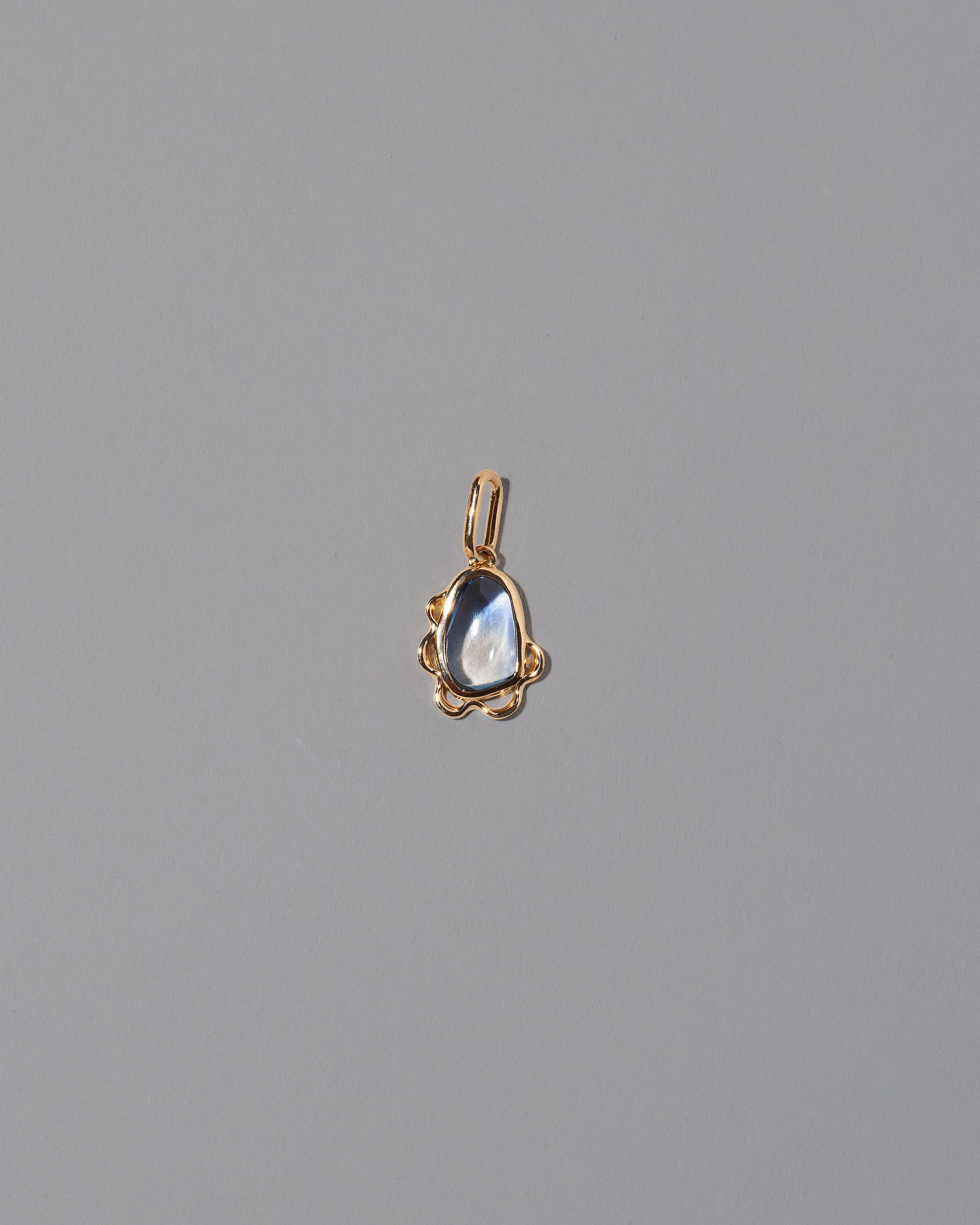 Karmic Balance Pendant on light color background.