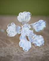 Closeup details of the Alex Rosenbaum Ghost Glass Flower on green background.