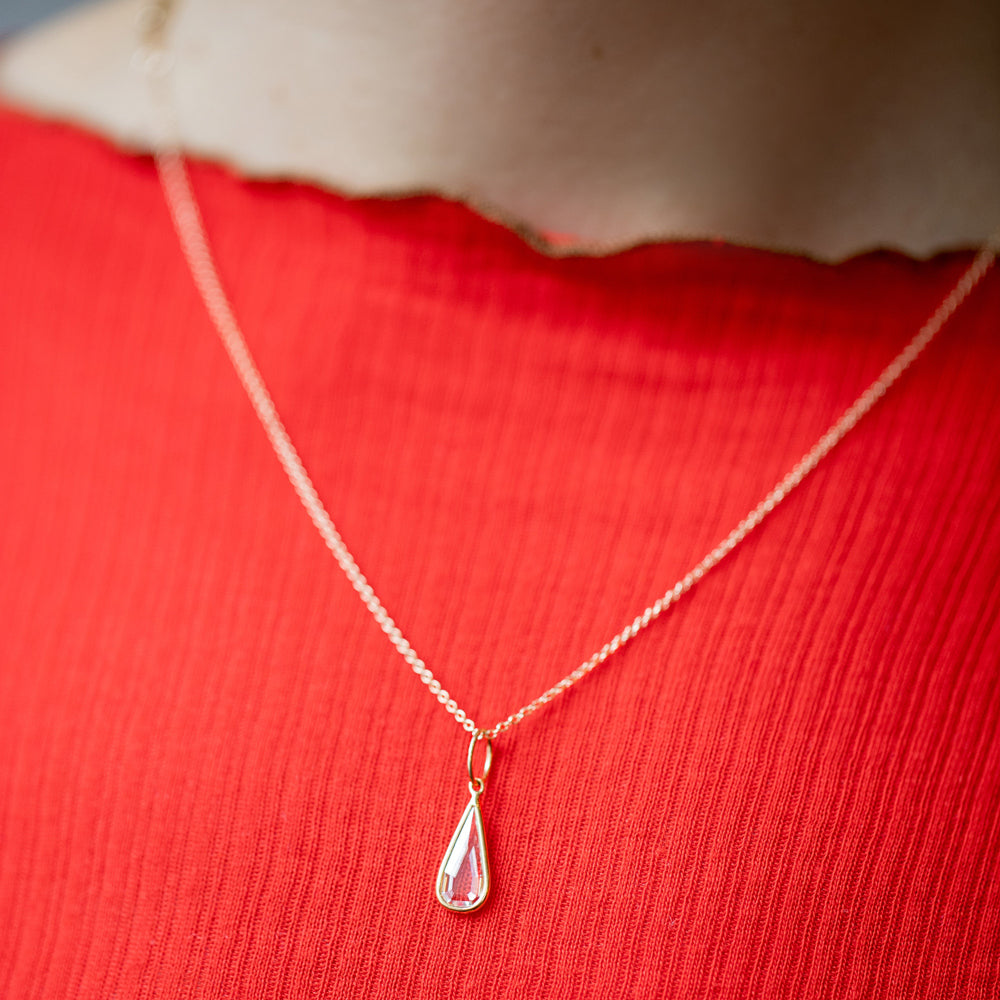 product_details::State Shifter Diamond Pendant paired with chain on model.