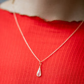 product_details::State Shifter Diamond Pendant paired with chain on model.