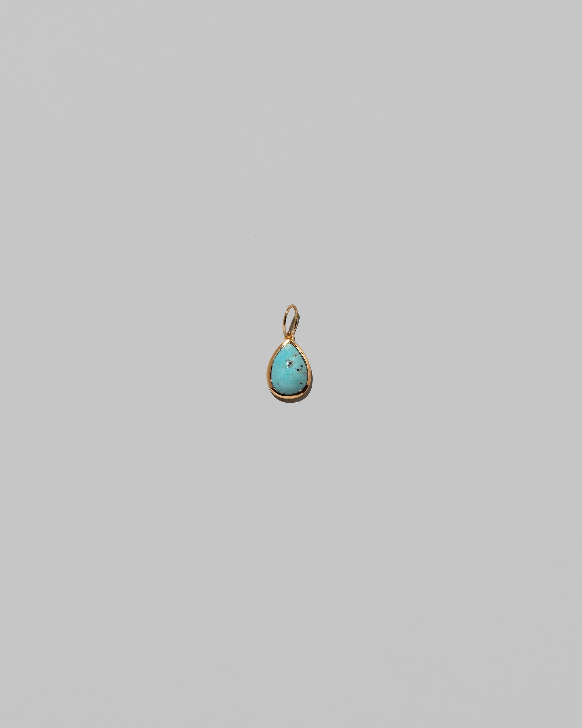 State Shifter Turquoise Pendant on light color background.