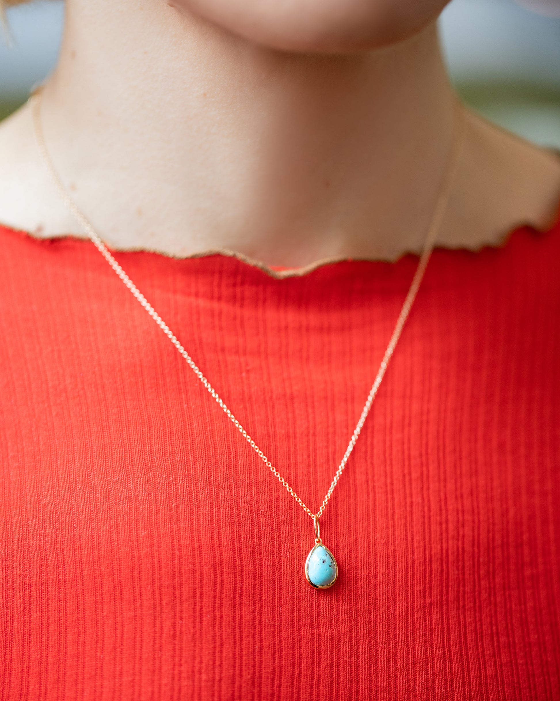State Shifter Turquoise Pendant paired with chain on model.