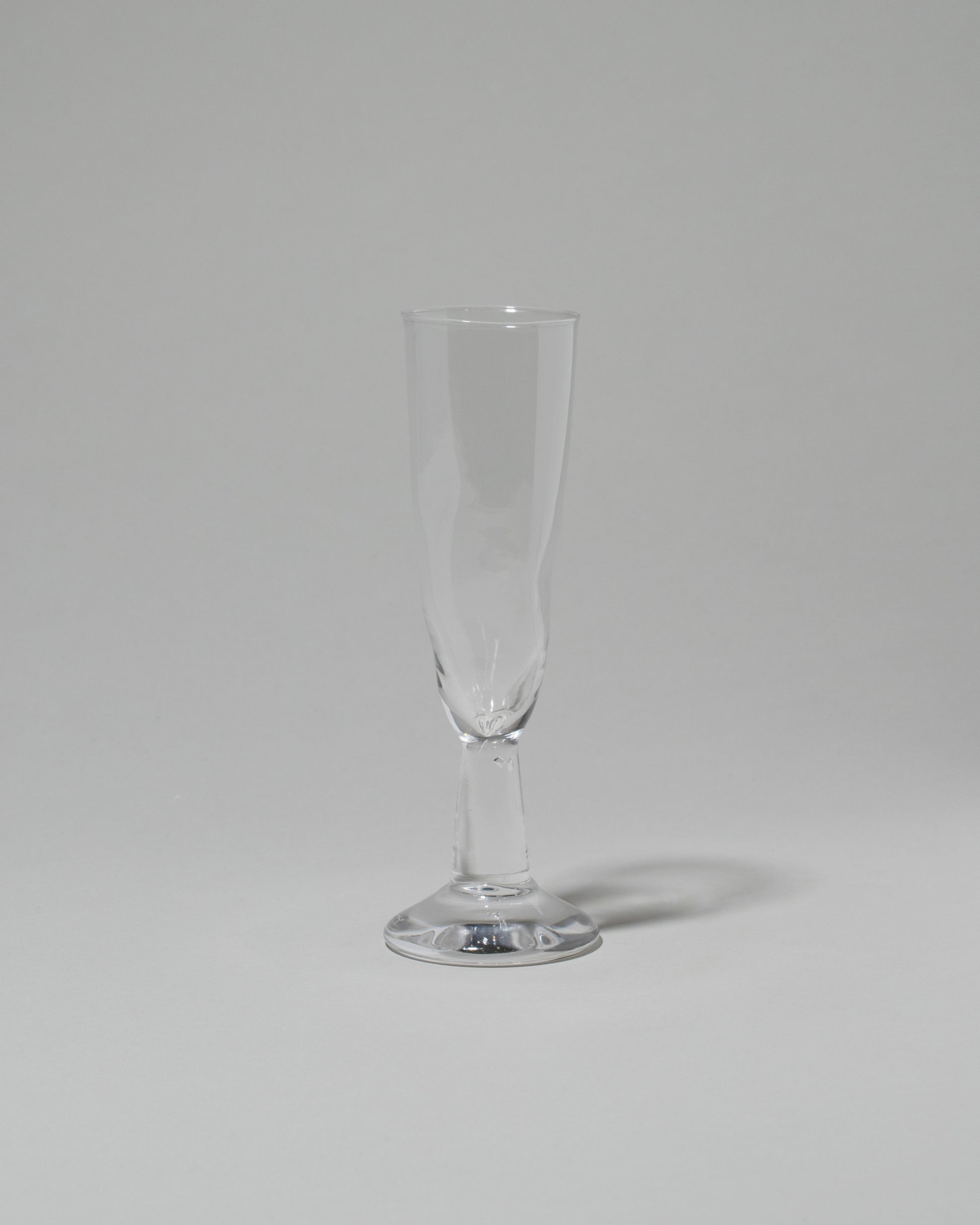 Silje Lindrup Twisted Flute Glass on light color background.