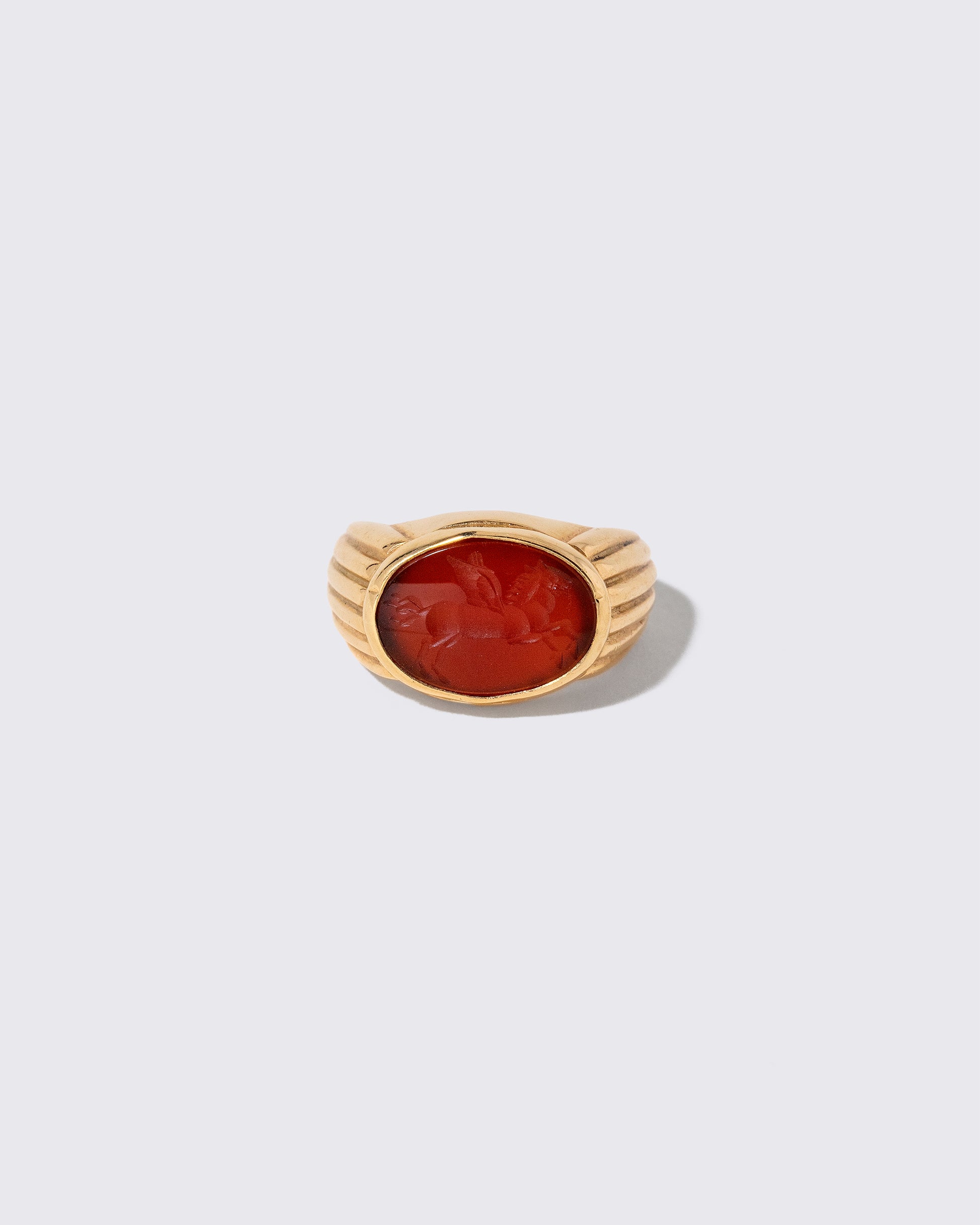 Vintage Bvlgari Carnelian Pegasus Intaglio Ring on light color background.