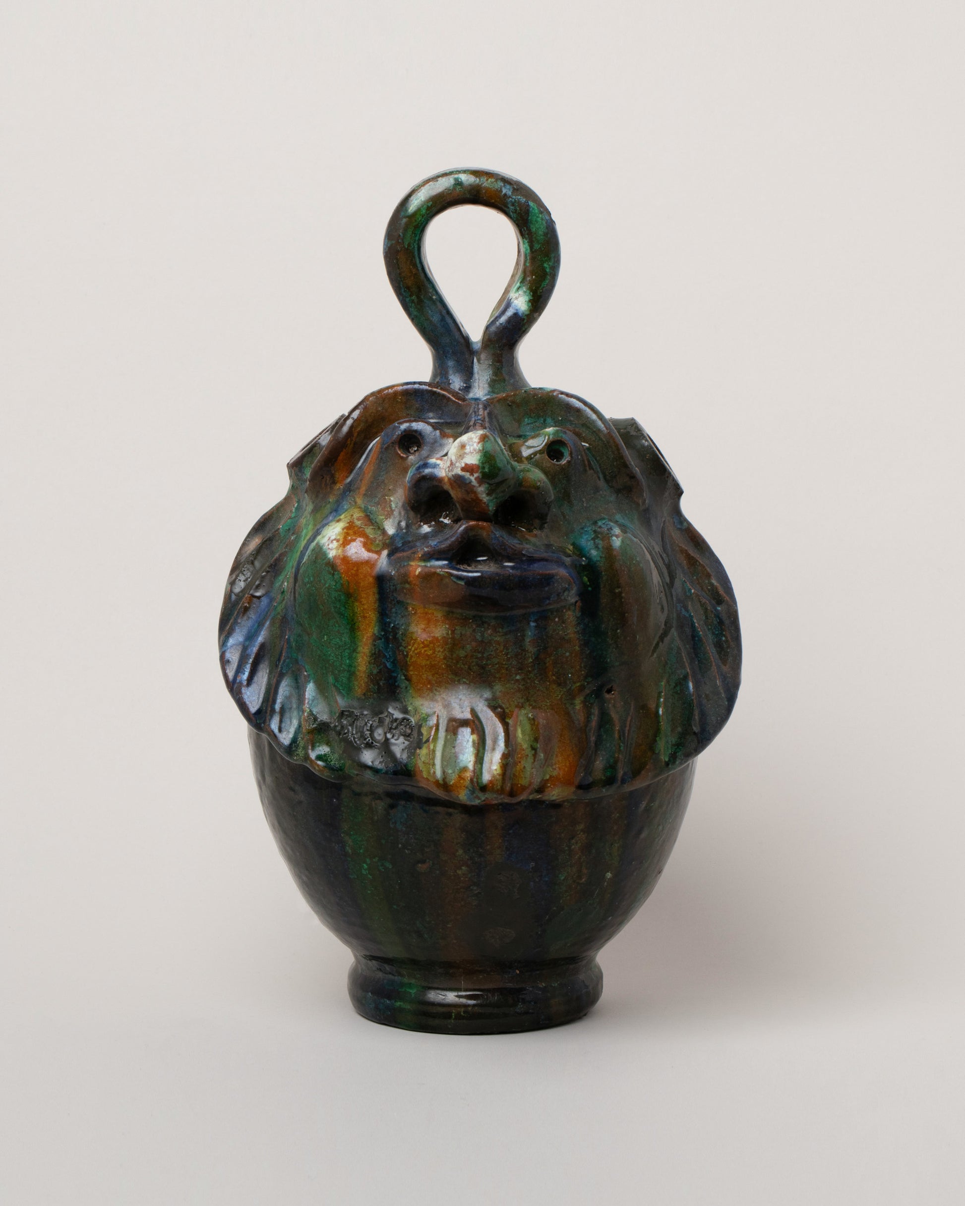 Apotropaia Head Flask on light color background.