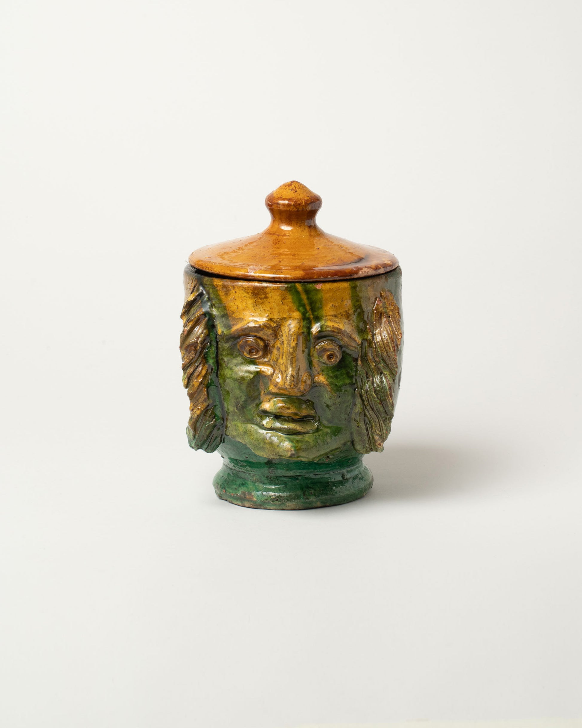 Apotropaia Lidded Head Jar Two on light color background.