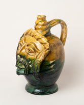 View from the side of the Apotropaia Large Head Jug Two on light color background.