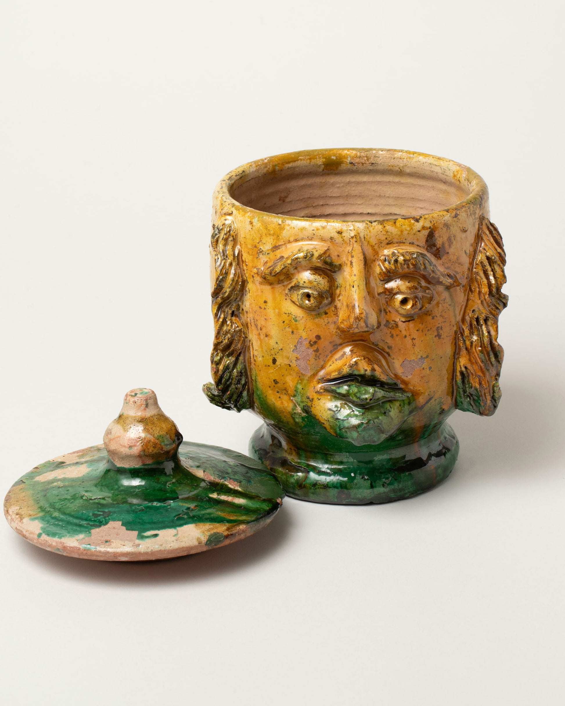 Detail view of the Apotropaia Lidded Head Jar One on light color background.