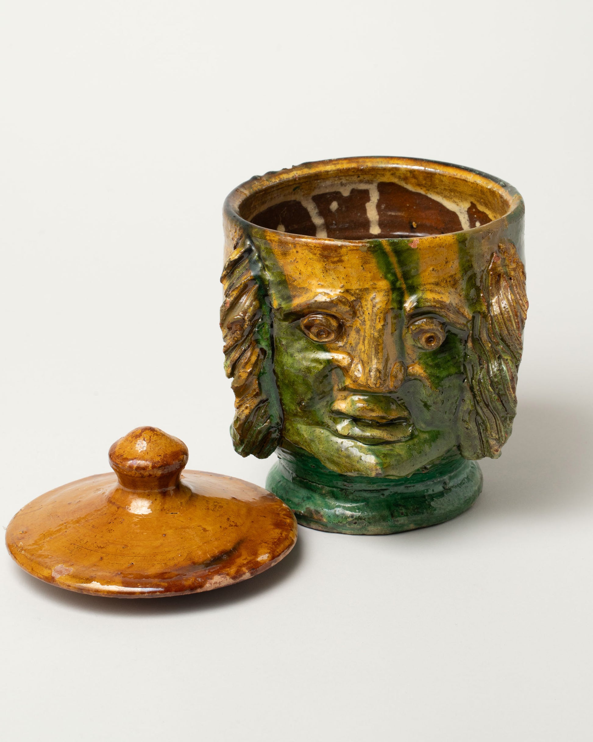 Detail view of the Apotropaia Lidded Head Jar Two on light color background.