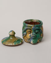 Detail view of the Apotropaia Small Head Jar on light color background.