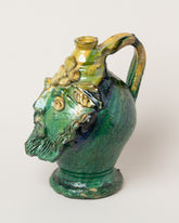 View from the side of the Apotropaia Small Head Jug on light color background.