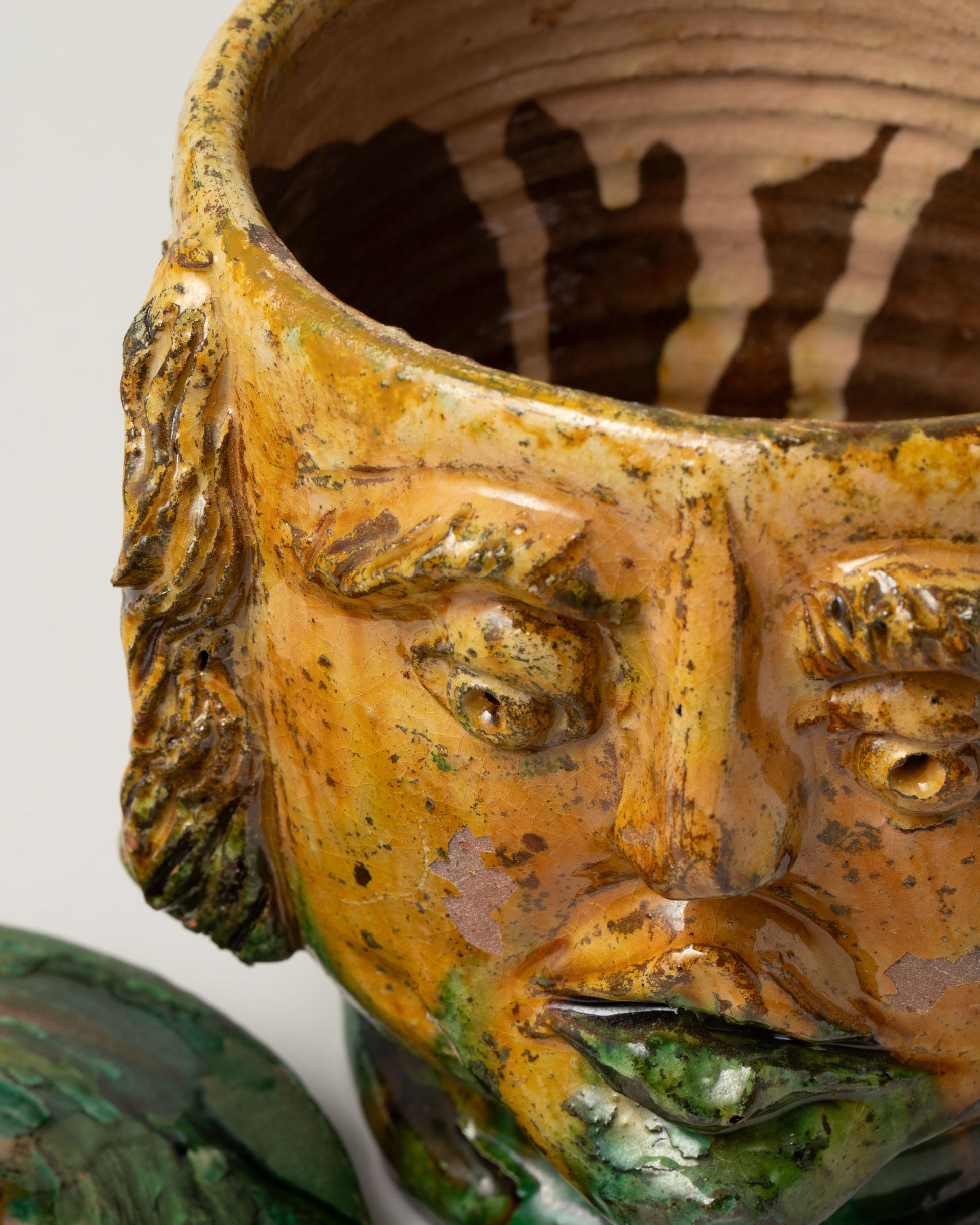 Closeup details of the Apotropaia Lidded Head Jar Two on light color background.