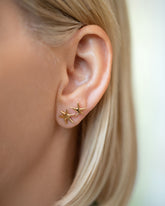 Shape One of the Small Verve Six Point and Shape Two Five Point Star Stud Earring singles on model.