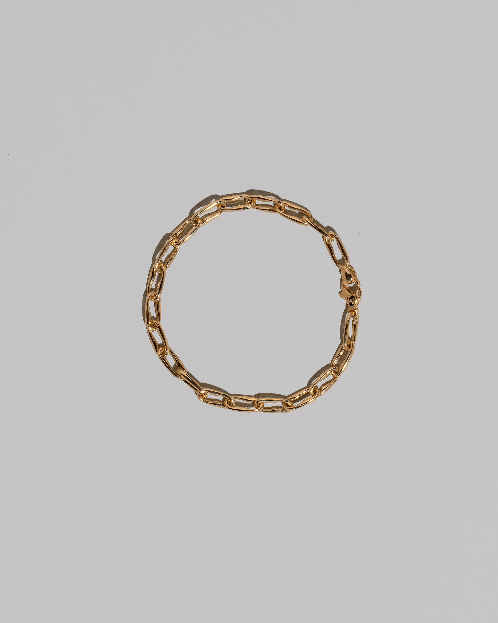 Wavy Link Chain Bracelet on light color background.