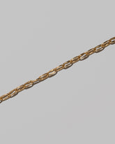 Closeup details of the Wavy Link Chain Necklace on light color background.