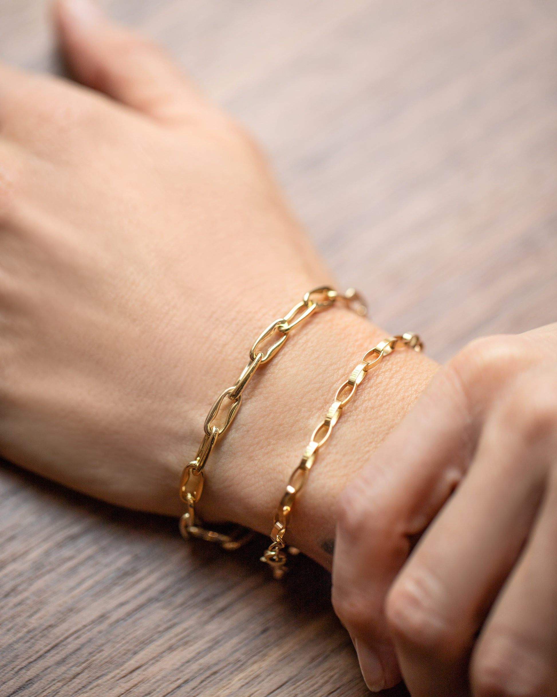 Wavy Link Chain Bracelet and Flat Oval Link Chain Bracelet on model.