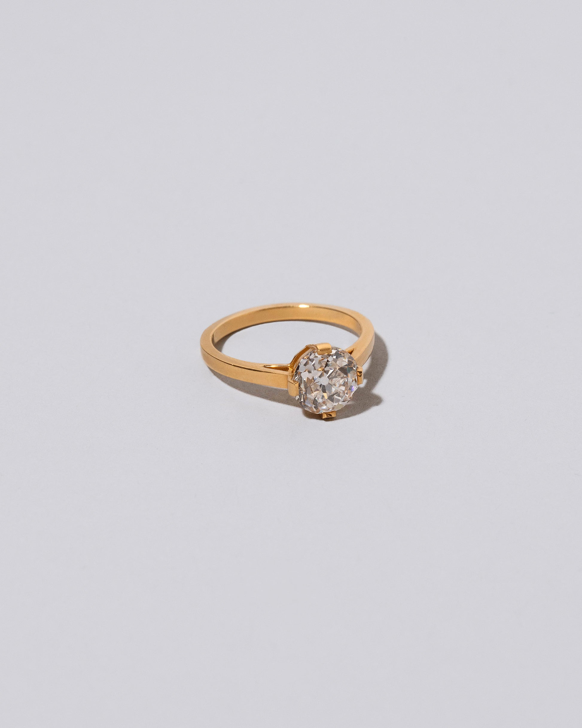 View from the side of  past version of the Super White Diamond Barragán Ring on light color background.