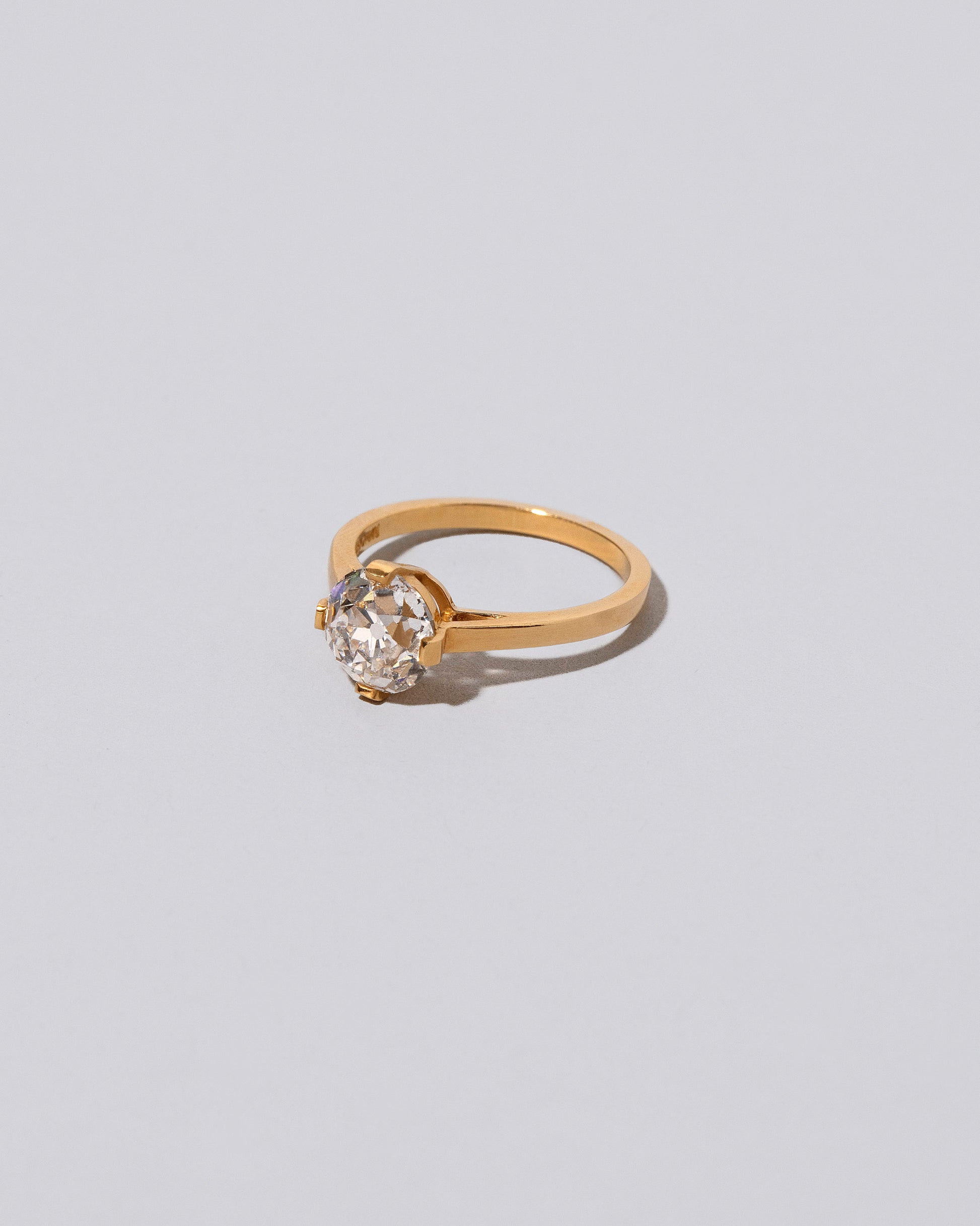View from the side of  past version of the Super White Diamond Barragán Ring on light color background.