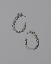 CRZM Sterling Silver Landform Hoop Earrings on light color background.