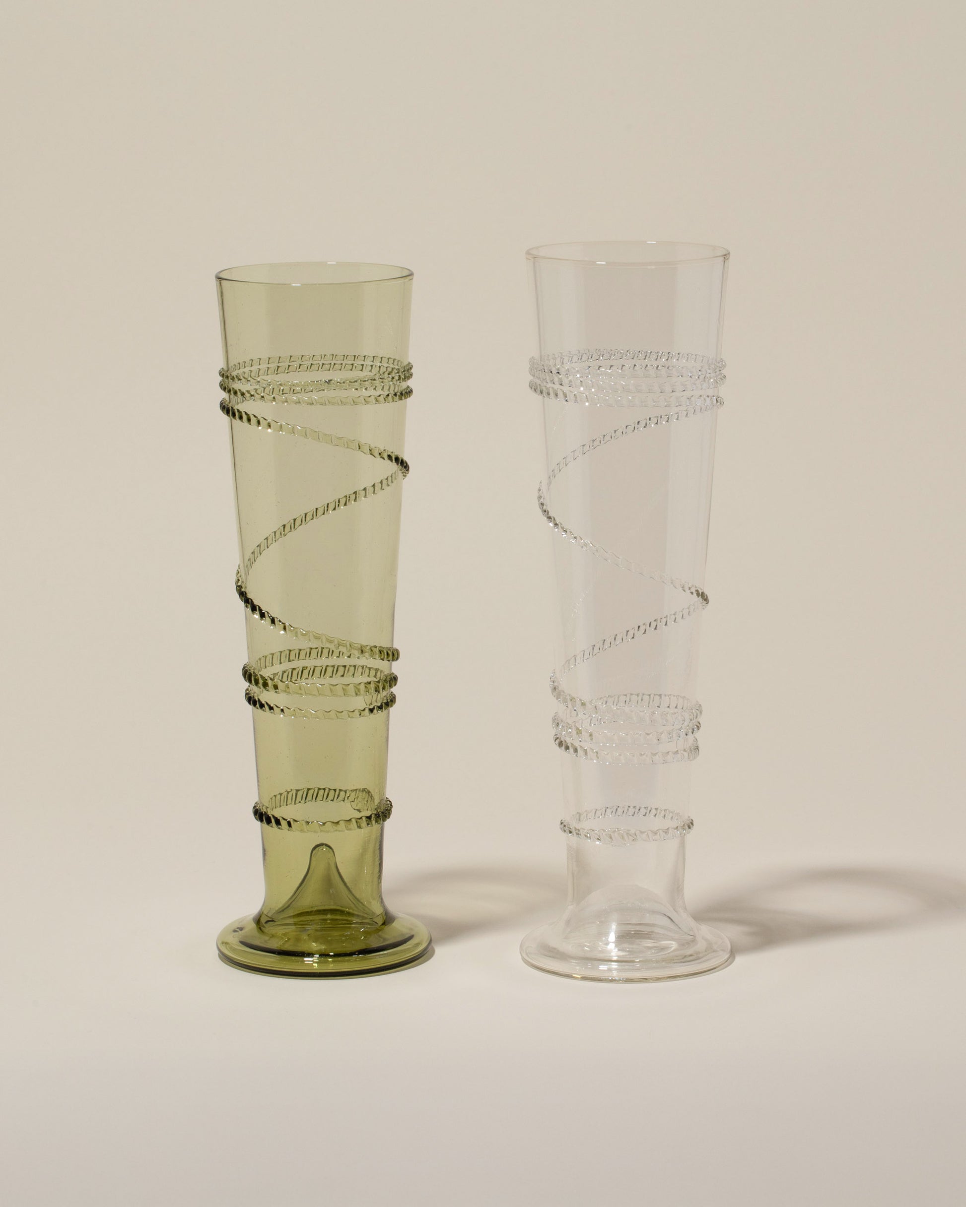 Bollenglass Design Green Small Spiral Vase and Clear Small Spiral Vase on light color background.