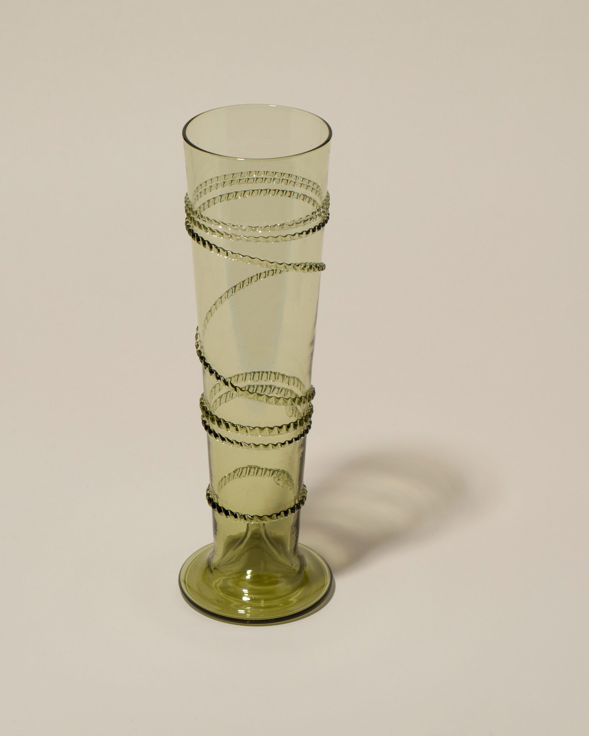 Closeup details of the Bollenglass Design Green Small Spiral Vase on light color background.