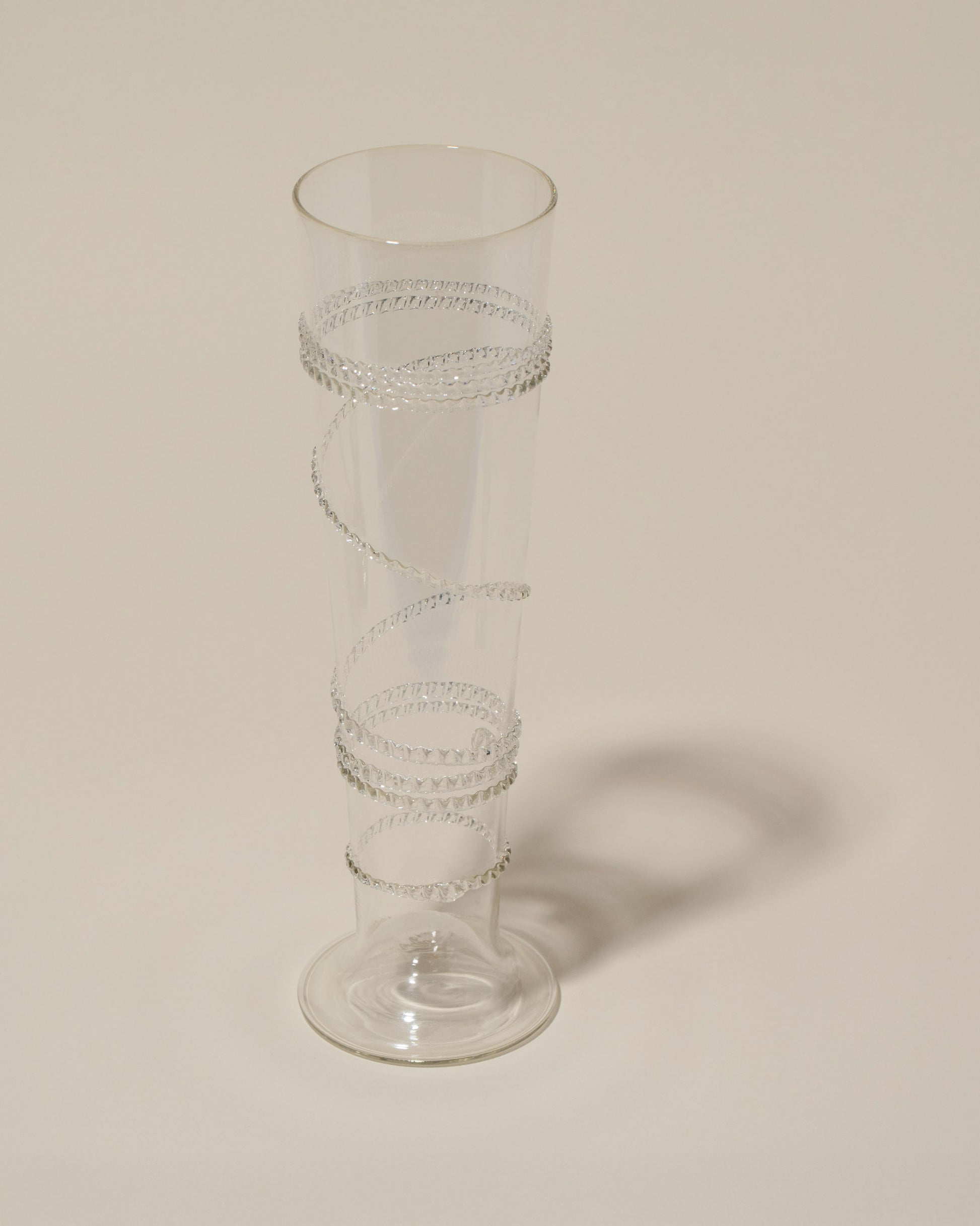 Closeup details of the Bollenglass Design Clear Small Spiral Vase on light color background.