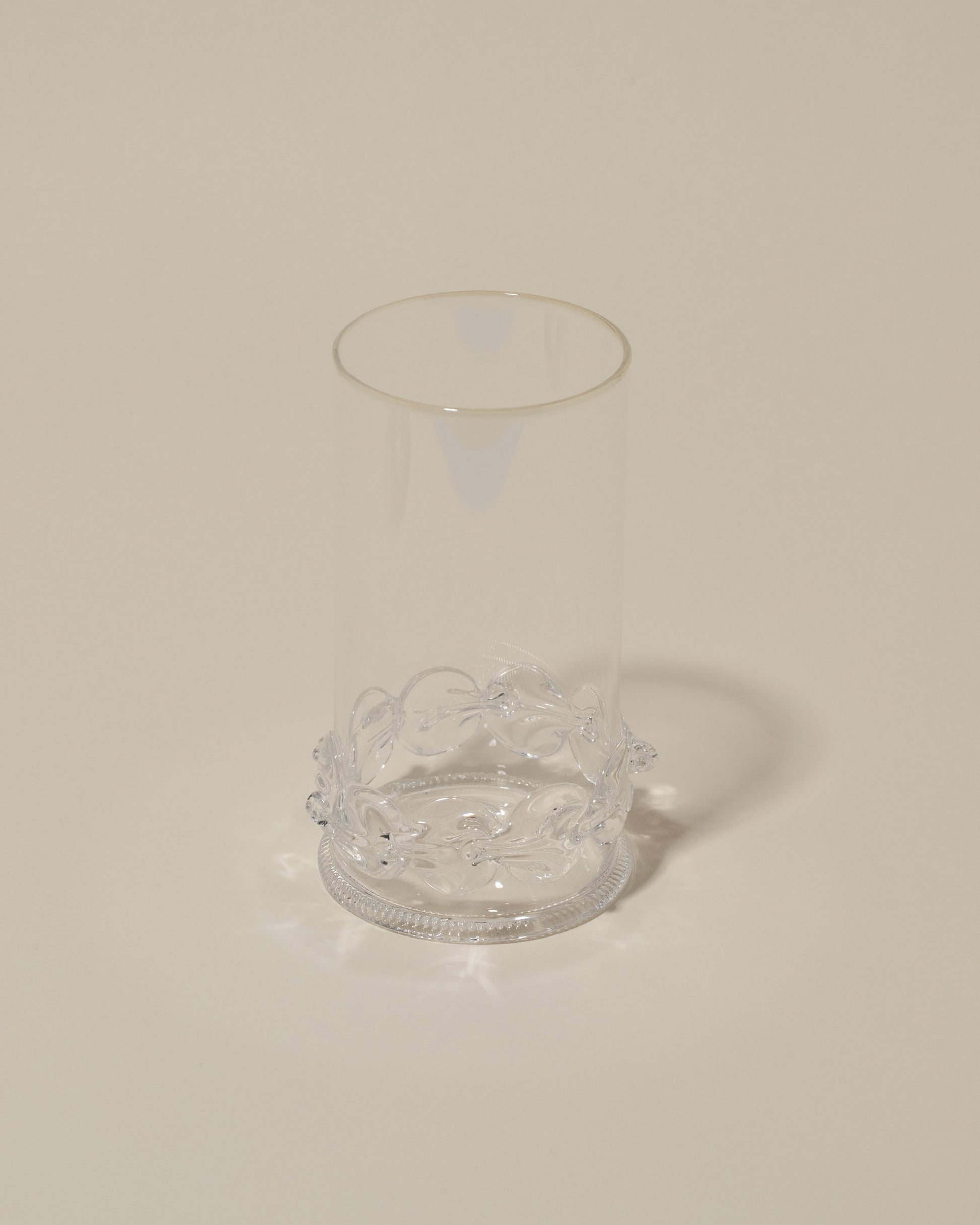 Closeup details of the Bollenglass Design Clear Dot Highball Glass on light color background.
