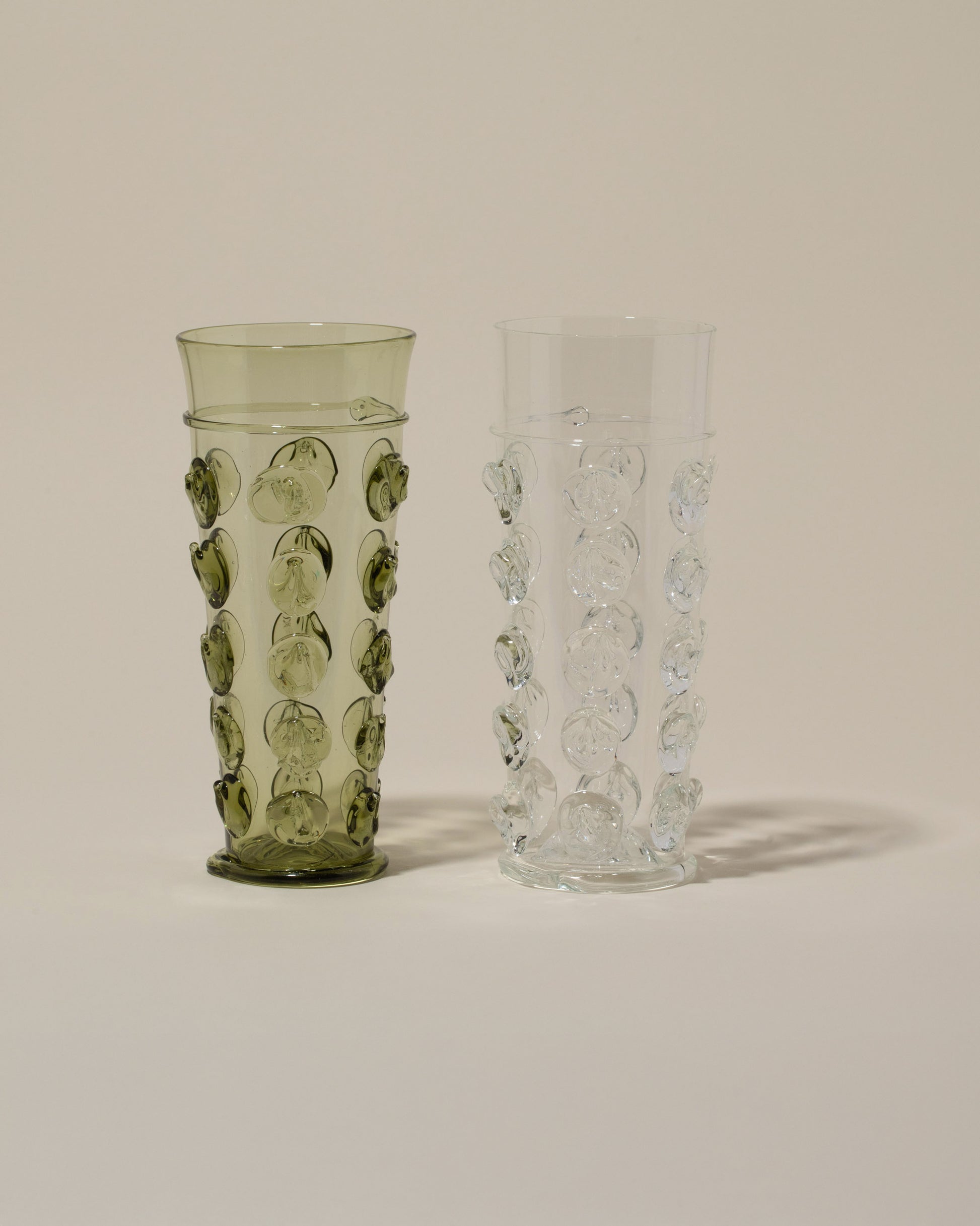 Bollenglass Design Clear Dot Water Glass and Green Dot Water Glass on light color background.