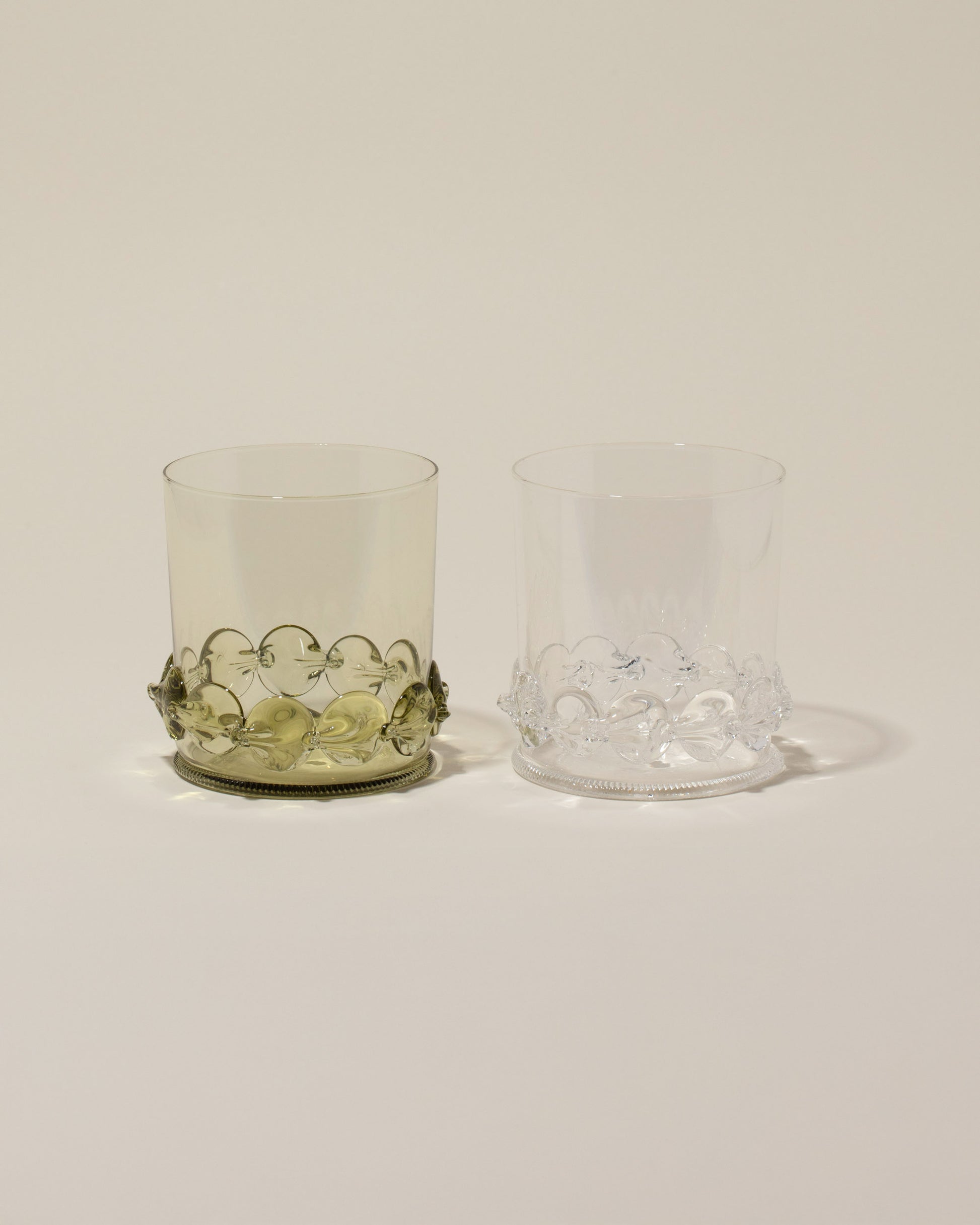 Bollenglass Design Clear Dot Whiskey Glass and Green Dot Whiskey Glass on light color background.
