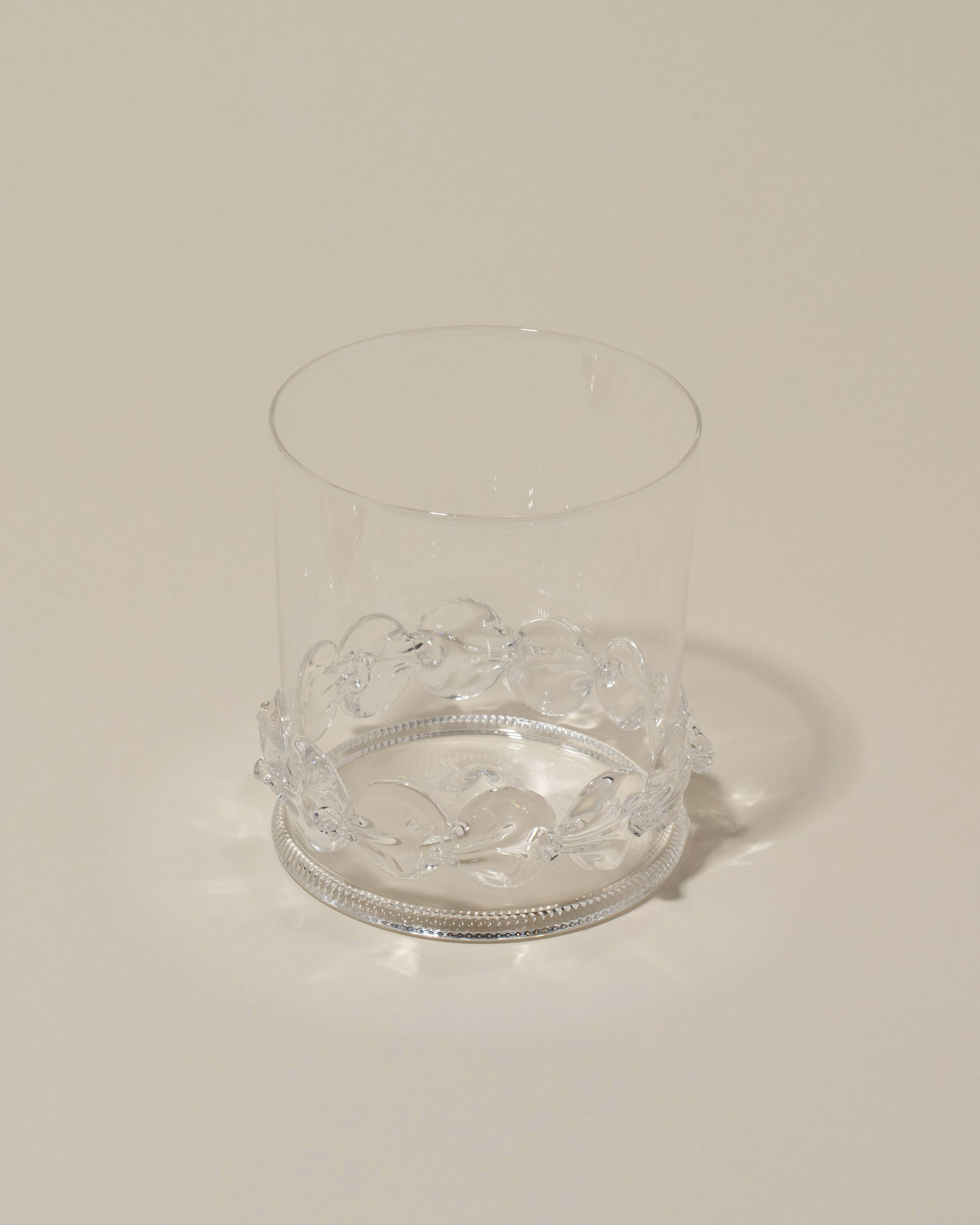 Closeup details of the Bollenglass Design Clear Dot Whiskey Glass on light color background.