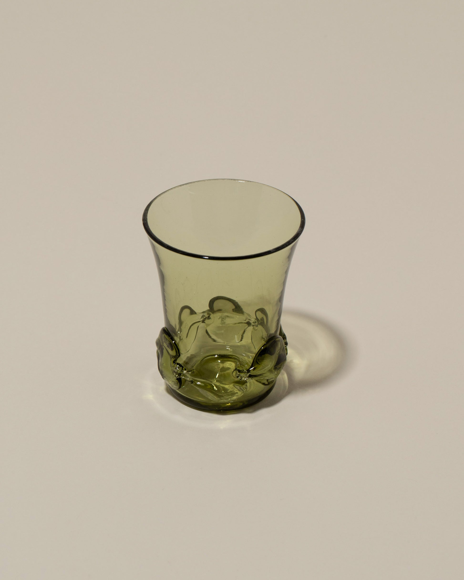 Closeup details of the Bollenglass Design Green Liquor Glass on light color background.