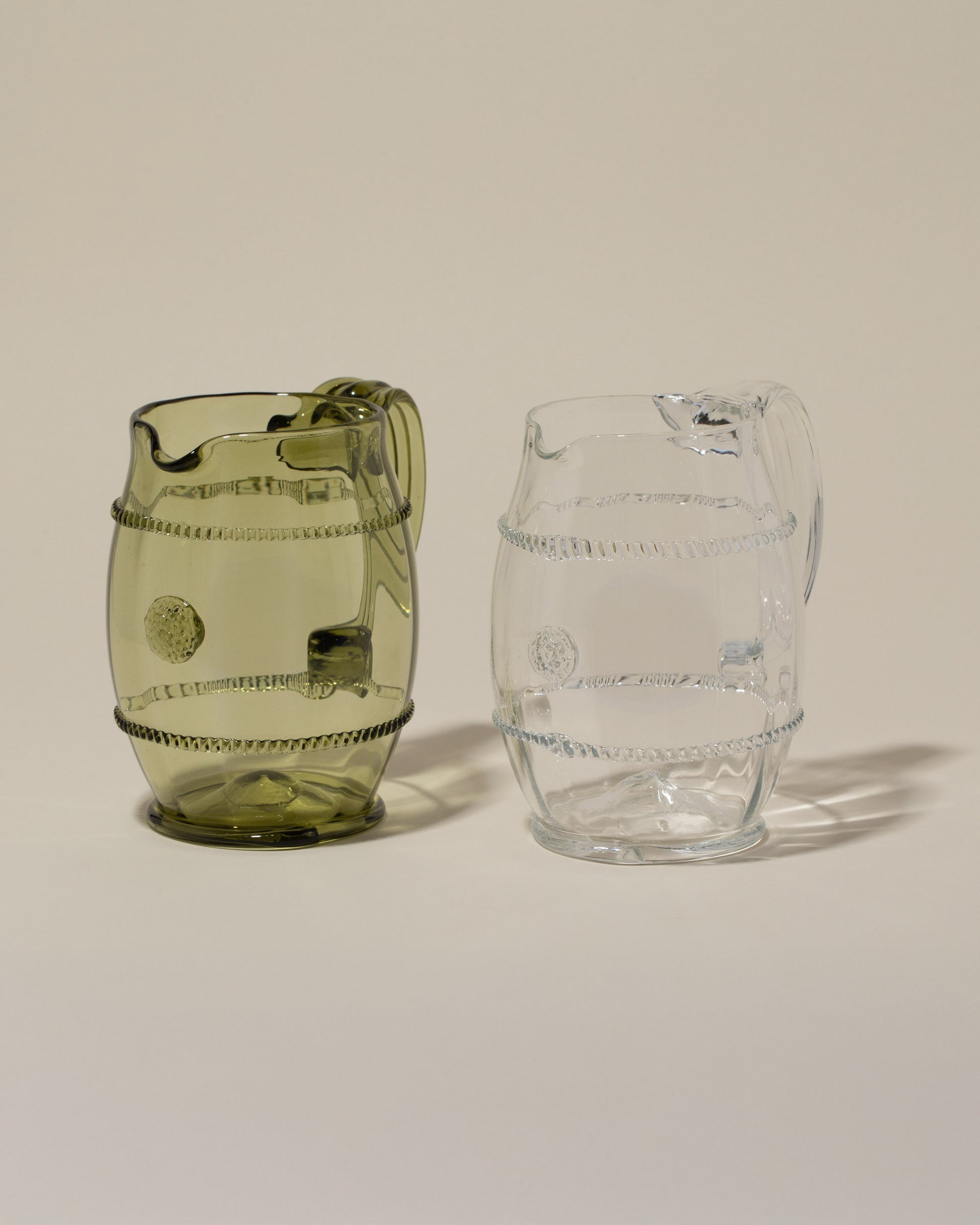 Bollenglass Design Green Petite Pitcher and Bollenglass Design Clear Petite Pitcher on light color background.