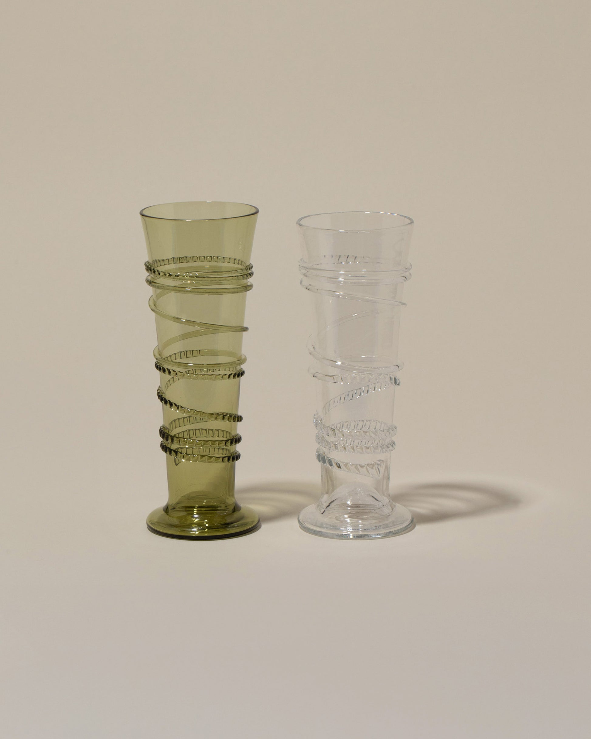 Bollenglass Design Green Petite Spiral Tumbler and Clear Petite Spiral Tumbler on light color background.