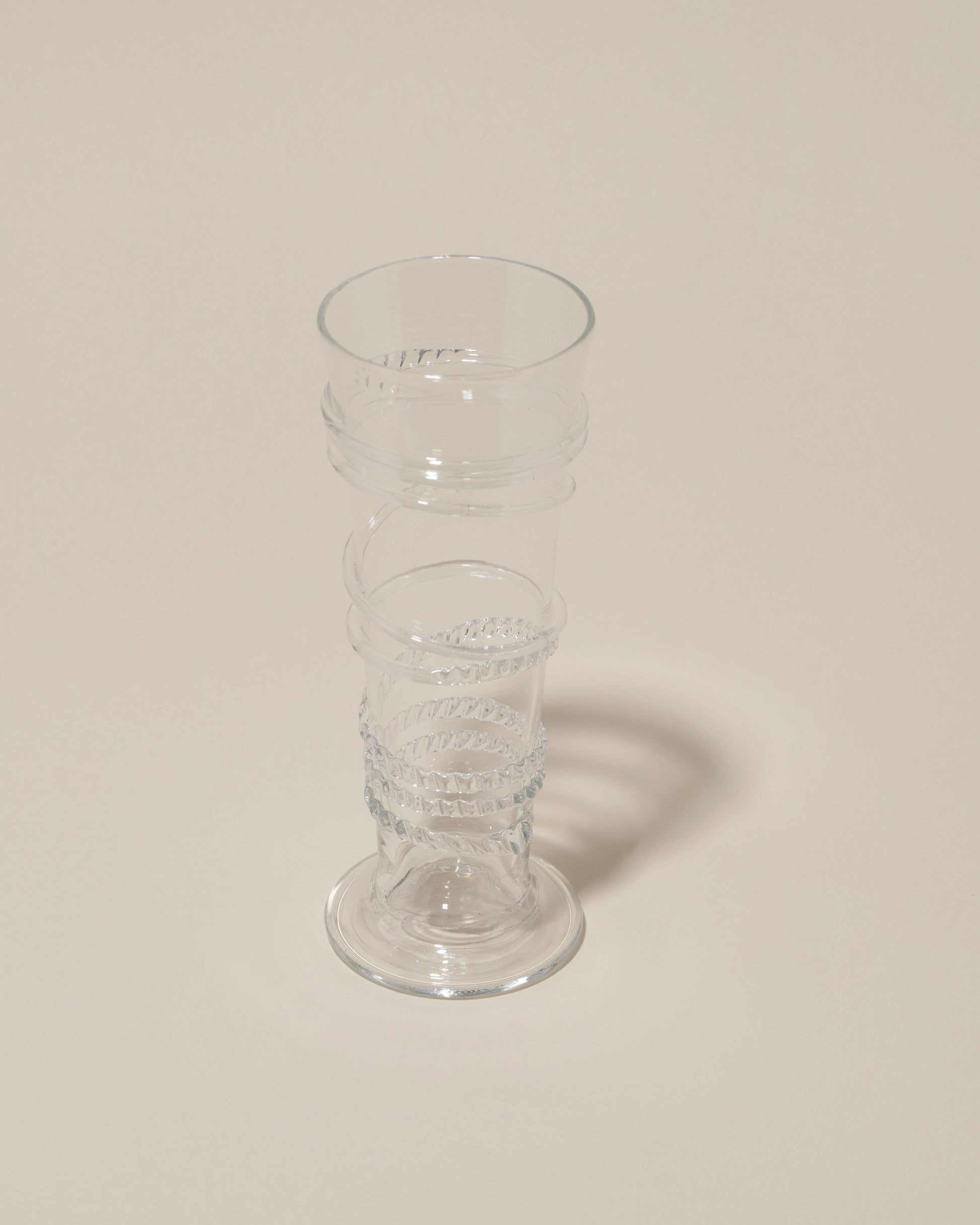 Closeup details of the Bollenglass Design Clear Petite Spiral Tumbler on light color background.