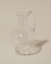 Closeup details of the Bollenglass Design Clear Spiral Jug on light color background.