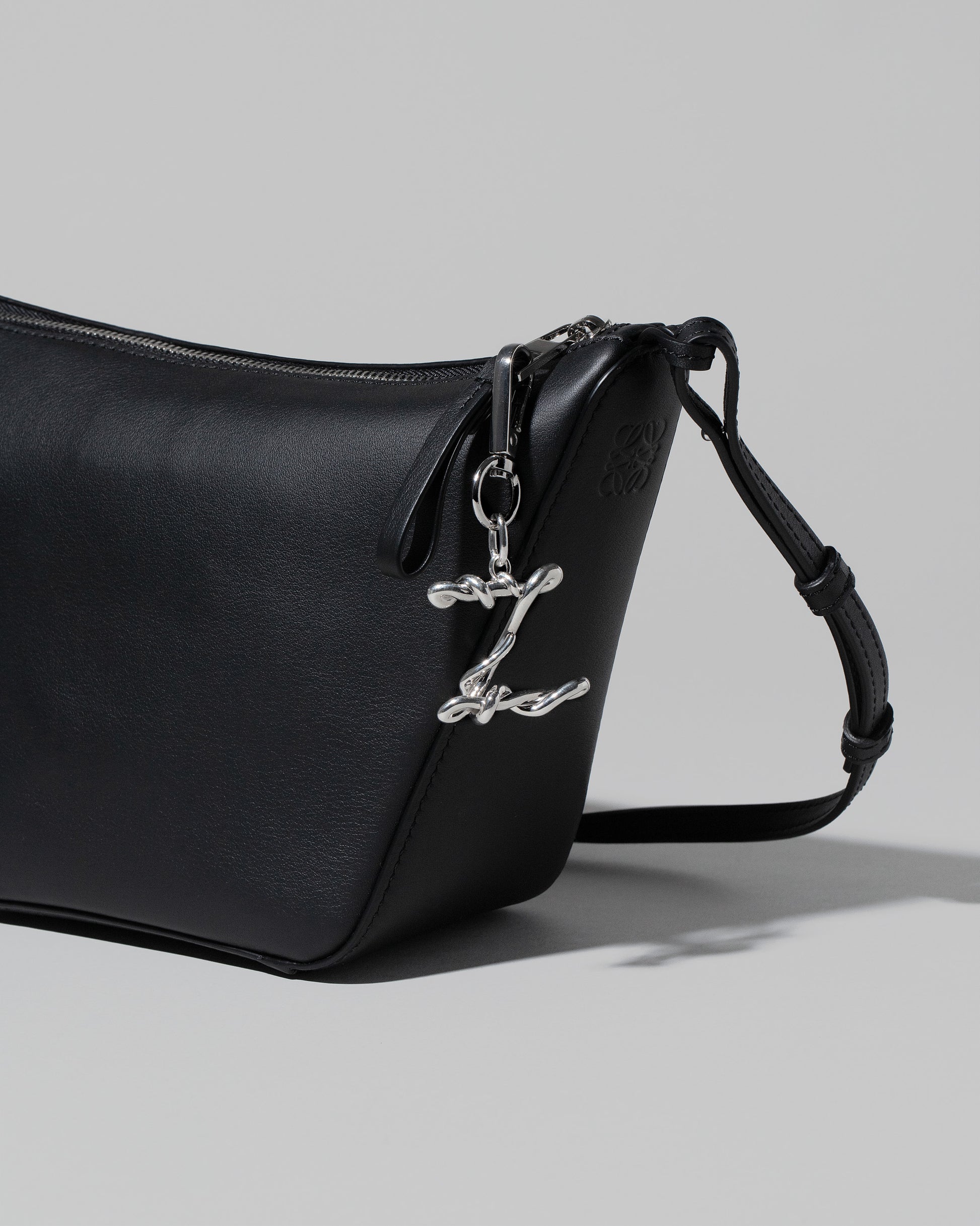 Closeup details of the CRZM Sterling Silver Letter Z Bag Charm on bag.