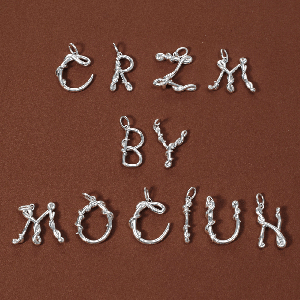 product_details::CRZM by Mociun spelled out using Large CRZM Large Sterling Silver Letter Charms on red color background.