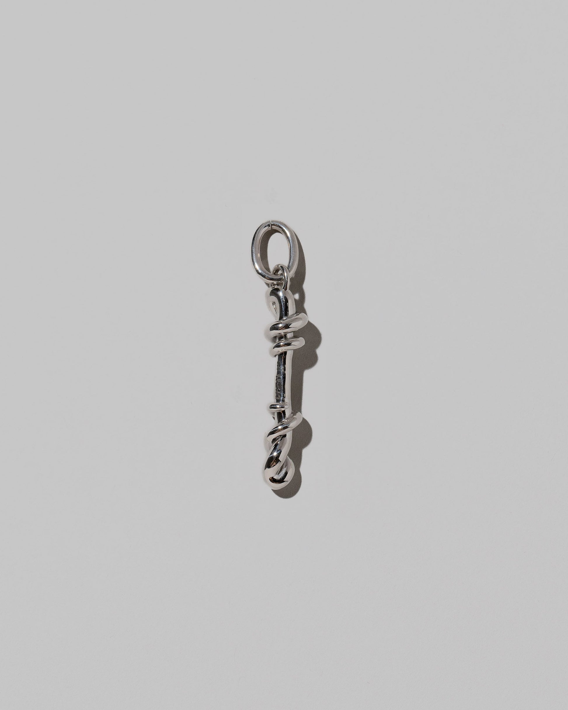 CRZM Sterling Silver Letter I Bag Charm on light color background.