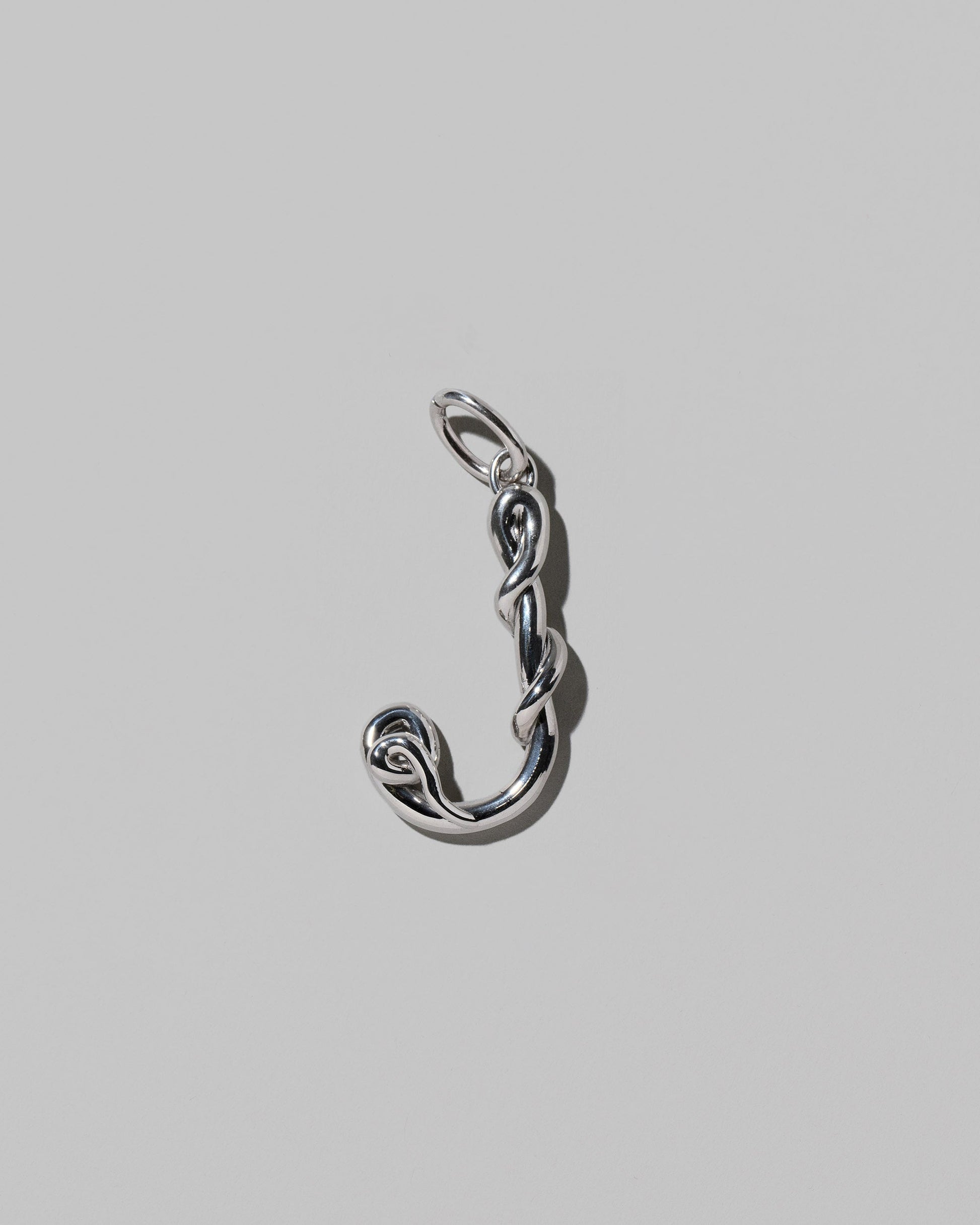 CRZM Sterling Silver Letter J Bag Charm on light color background.