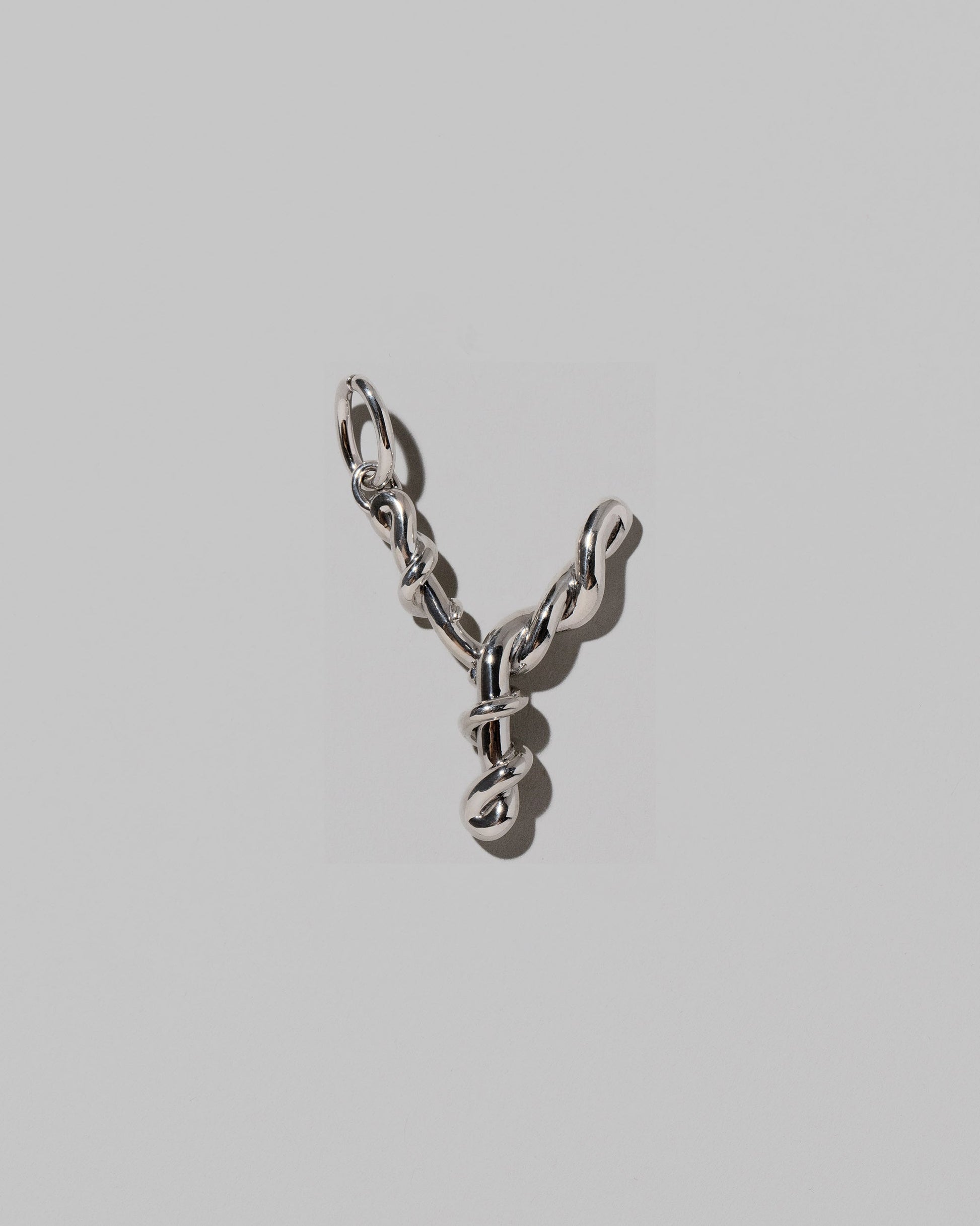 CRZM Sterling Silver Letter Y Bag Charm on light color background.