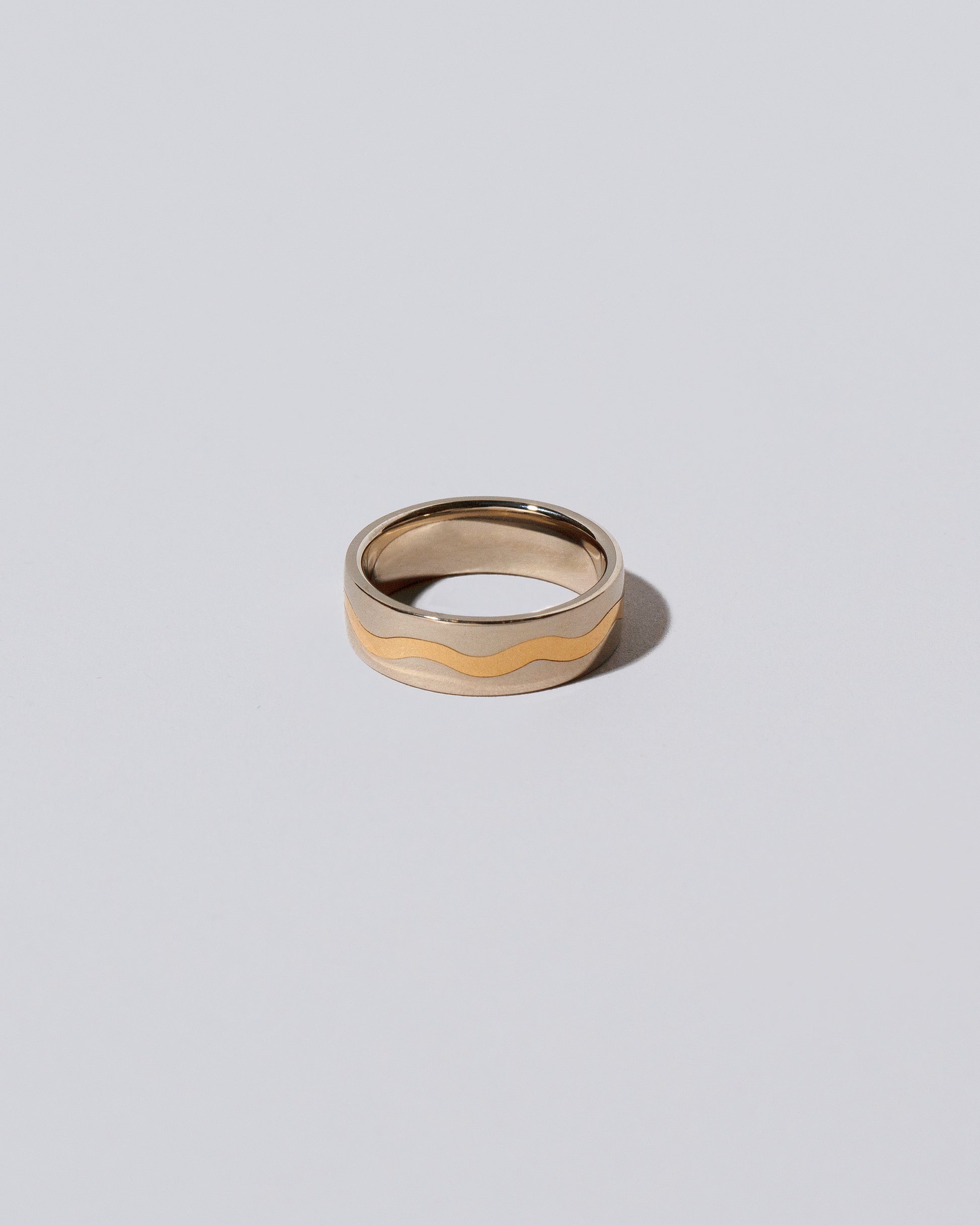 6mm Platinum Outside, Yellow 18K Inside Swimming Pool Band on light color background.