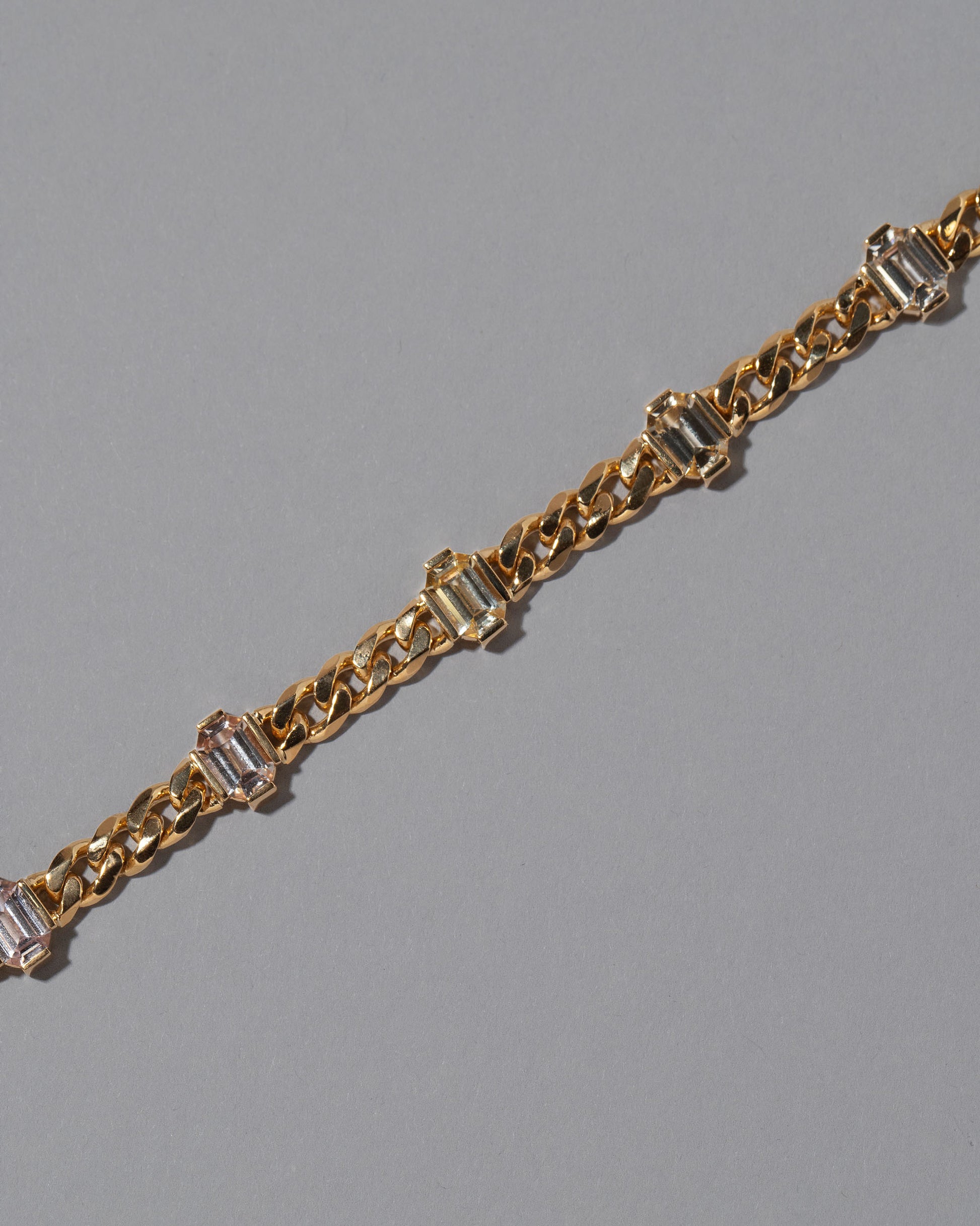 Closeup details of the Envelop Bracelet on grey color background.