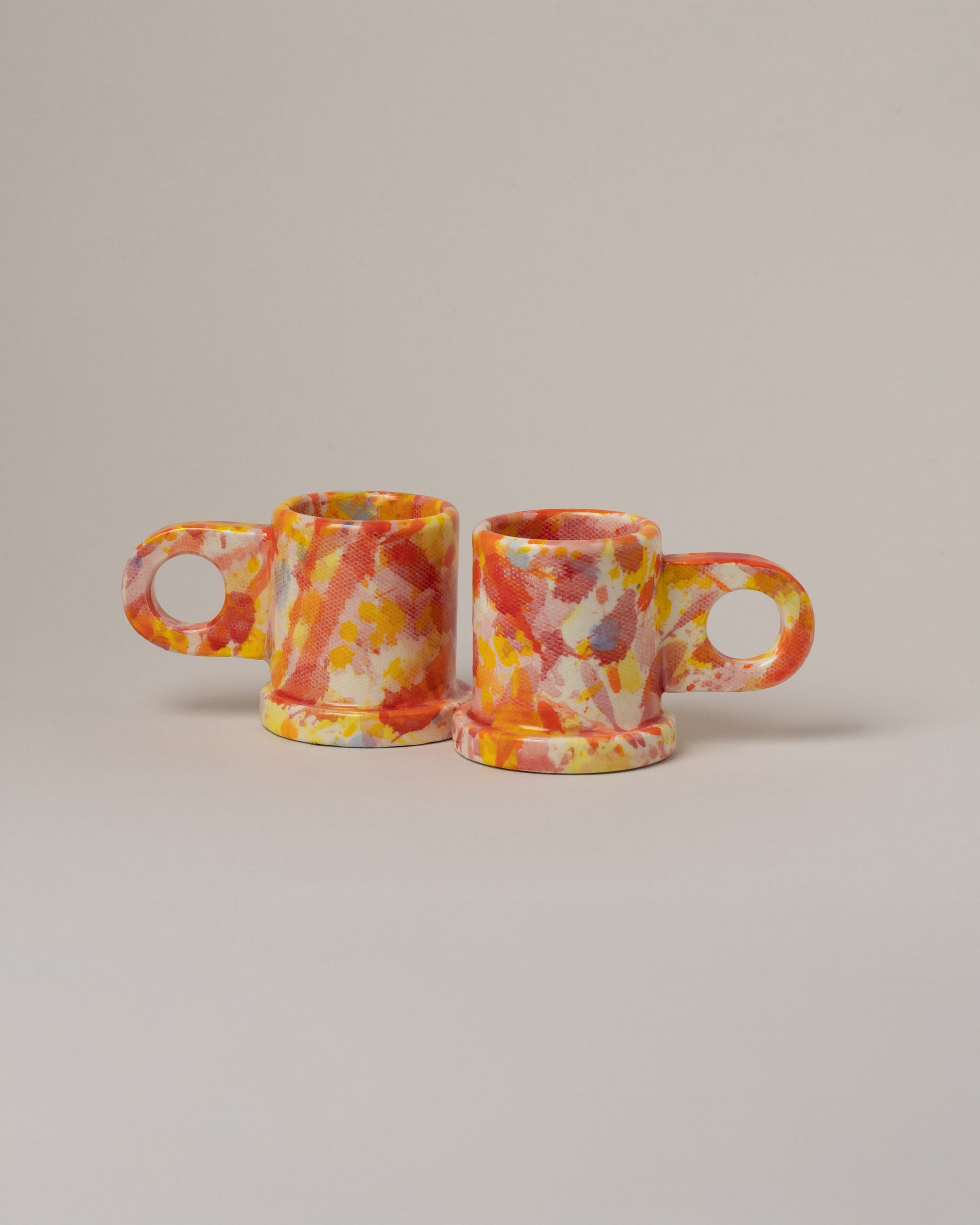 Echo Park Pottery by Peter Shire Tomato & Yellow Splatter Espresso Mug Set on light color background.