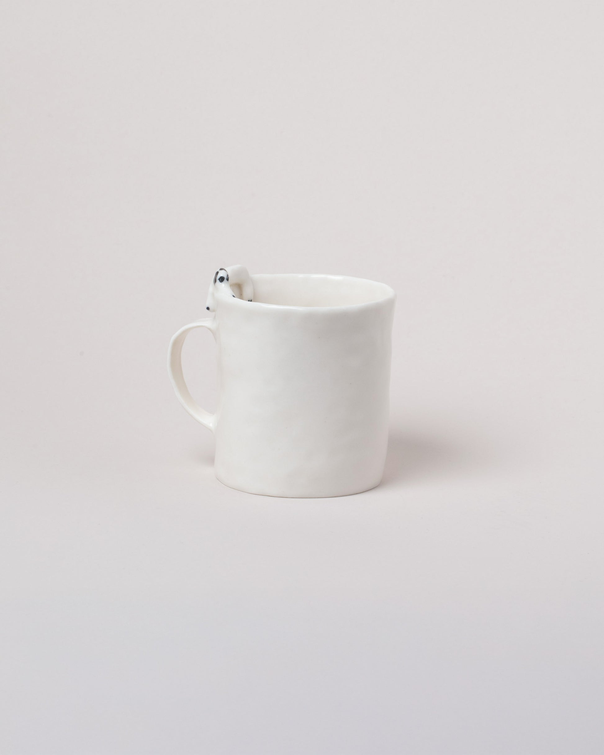 Eleonor Boström Hiding Dog Mug on light color background.
