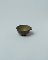 Emris Dark Stoneware Teenie Bowl on light color background.