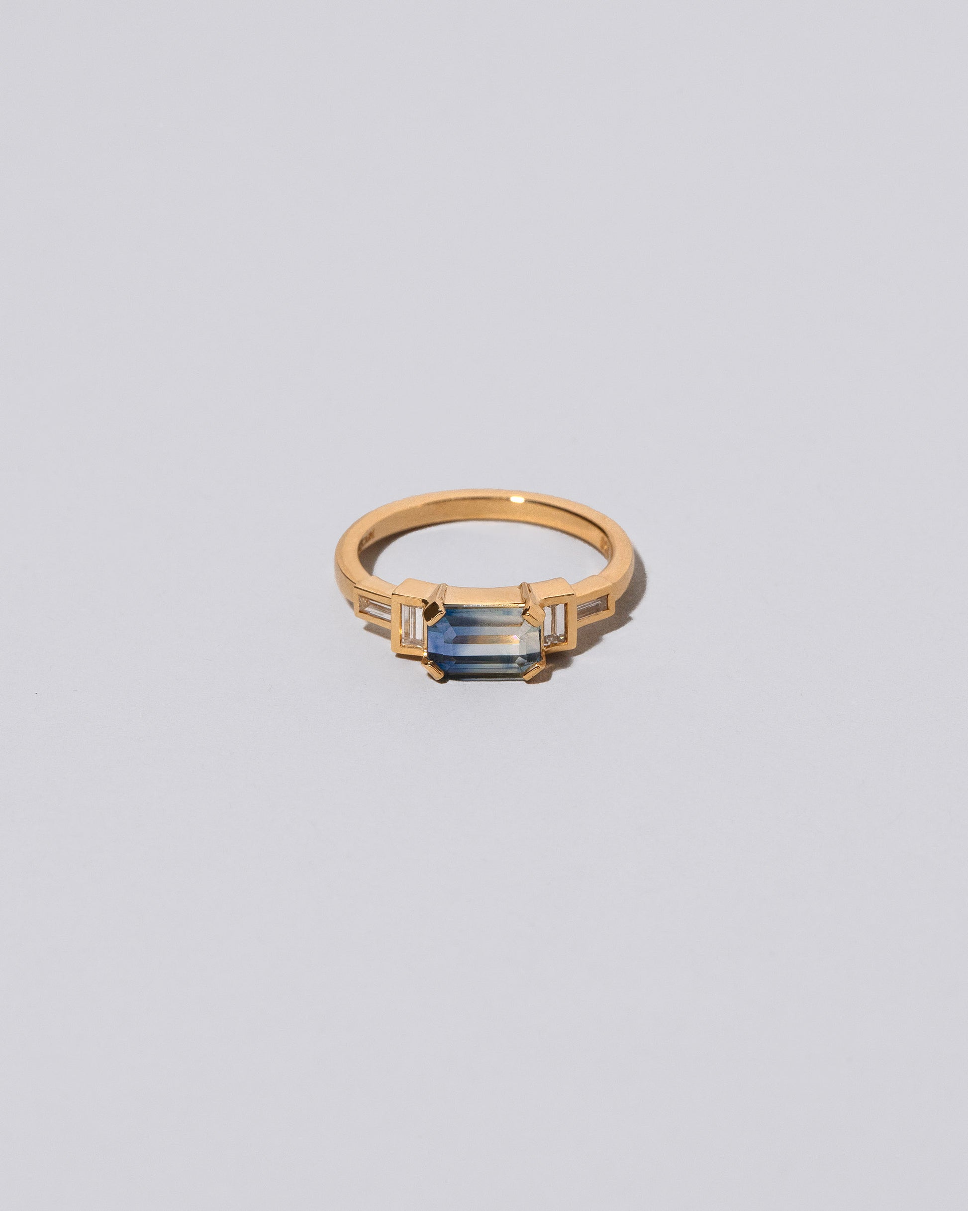 Blue Sapphire Expression Ring on light color background.