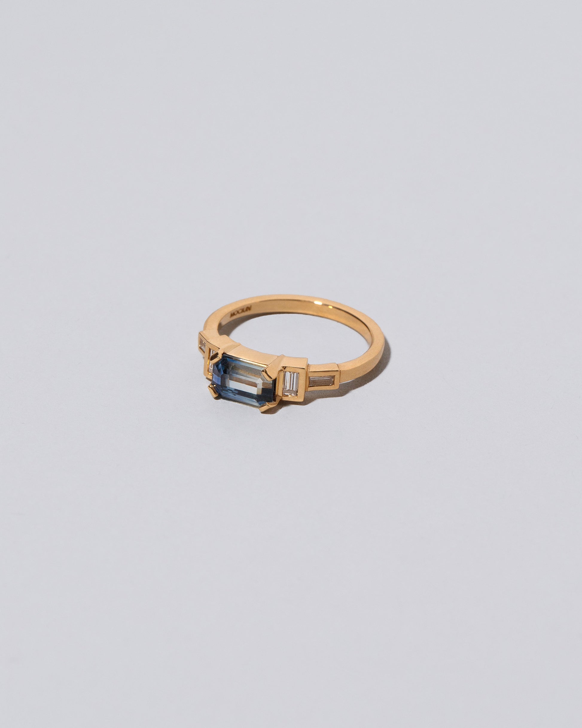 View from the side of the Blue Sapphire Expression Ring on light color background.