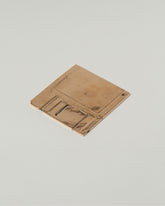 View from the back of the Pearce Objects Cast Bronze Floppy Disk on light color background.