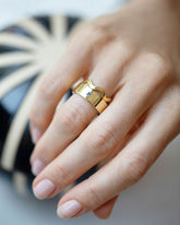 Gold 2.5mm Ripple Band and Gold Yogo Mine Blue Montana Sapphire 6mm Square Cut Piet Band on model.